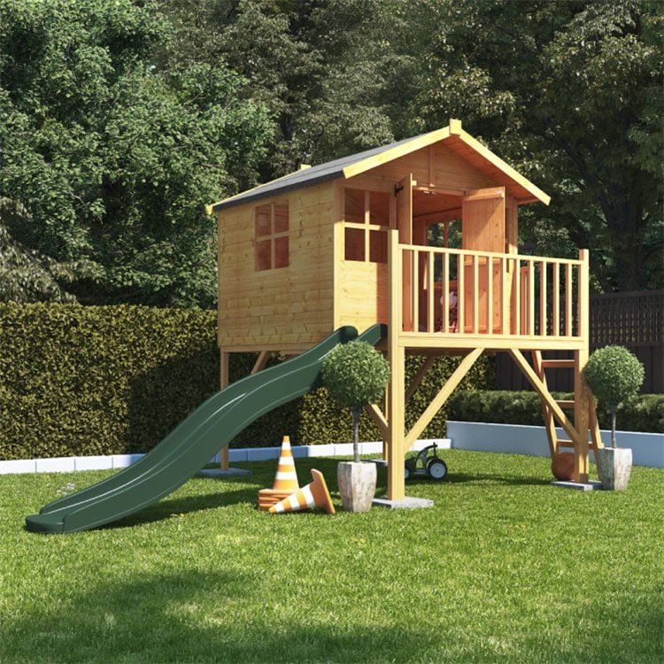 Lollipop Junior Tower playhouse with slide standing in a sunny green garden